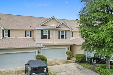 Traditional home featuring driveway and a shingled roof