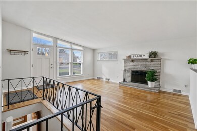 This living room has large front windows that let