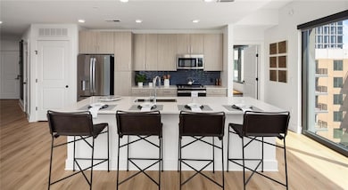 Kitchen featuring backsplash, stainless steel appl