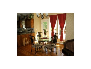 Breakfast room with gleaming hardwood floors.