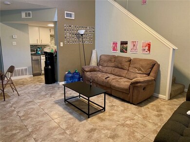 Living area with light tile patterned floors, visi