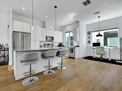 Kitchen featuring a breakfast bar, appliances wit