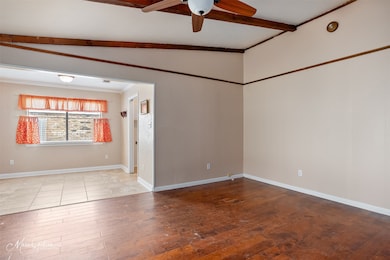 Spare room with ceiling fan, ornamental molding, and hardwood / wood-style flooring