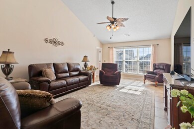 Living room with light tile patterned floors, a te
