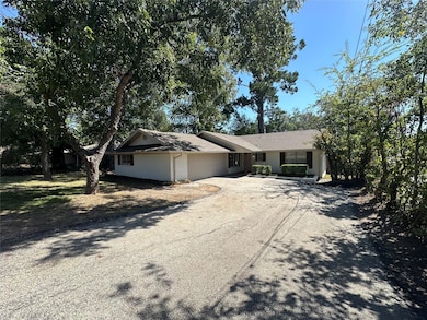 Ranch-style home with an attached garage, driveway