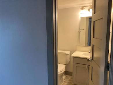 Half bathroom with toilet and vanity