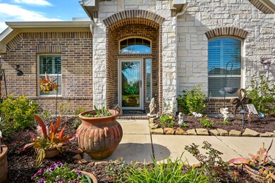 Brick and white stone front elevation with professional landscape yard to this 1 story home!