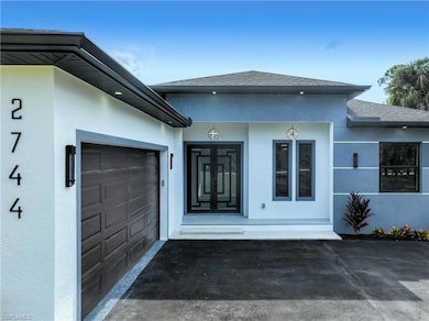 Doorway to property with roof with shingles and stucco siding