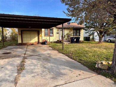 View of front of home with a garage and a front la