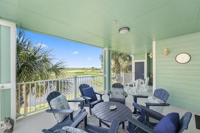 Gather with family and friends on the expansive covered balcony while soaking in breathtaking coastal views and refreshing breezes.