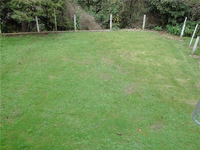 Level back yard with fence posts so a fence can ea