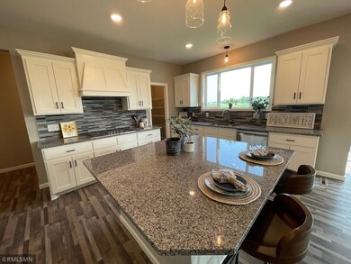 Kitchen with built in appliances, granite countertops and tile backsplash