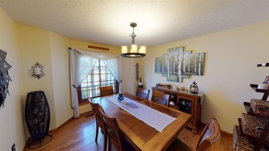 The hardwood floors run from the foyer into the di