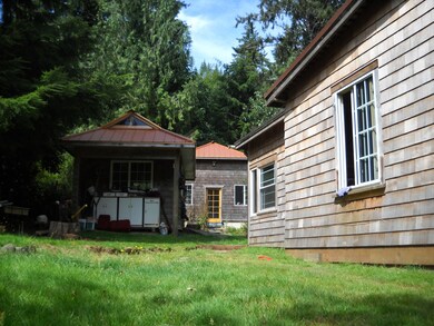 SIDE OF HOME VIEW OF STUDIO & GARAGE