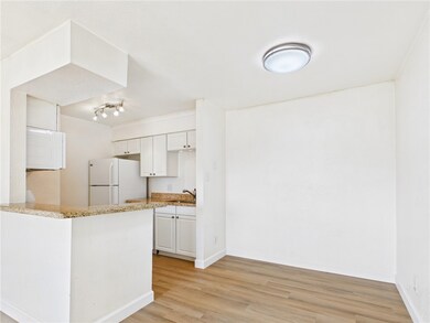 Kitchen featuring freestanding refrigerator, light