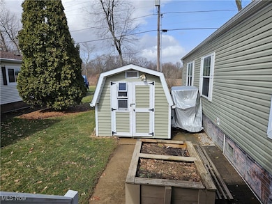 View of shed featuring a vegetable garden