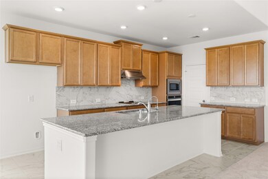This kitchen is by far any chef’s dream! This spacious kitchen features high ceilings, light stained wood cabinets, granite countertops, SS appliances, modern tile backsplash, recessed lighting, extended counter space, granite kitchen island with space for breakfast bar, and a walk-in pantry all overlooking your huge family room.
