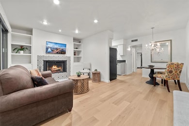Living area with light wood finished floors, a ch