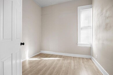 Unfurnished room featuring baseboards and light w