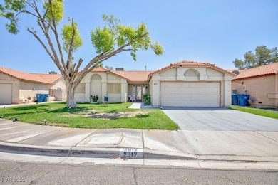 Mediterranean / spanish-style home featuring a tiled roof, stucco siding, an attached garage, concrete driveway, and a front lawn