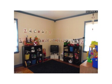 The smaller 1st floor bedroom also has wood flooring and window treatments.  Also great for an office or play room.