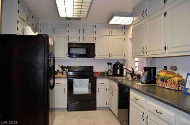 Lots of cabinets in the kitchen with near-new blac