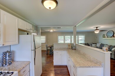 Kitchen with dark hardwood / wood-style floors, ce