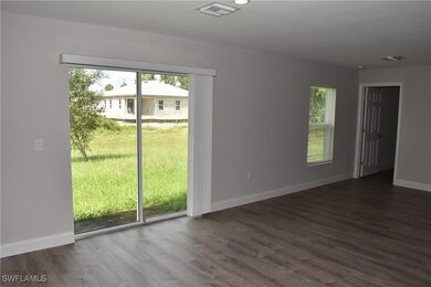 Empty room featuring dark hardwood / wood-style flooring
