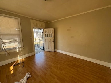 Empty room with crown molding and dark hardwood / wood-style floors