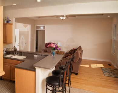 Kitchen with a breakfast bar opens to the Living R
