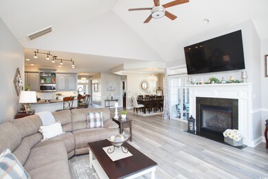 Living room with ceiling fan, light hardwood / woo