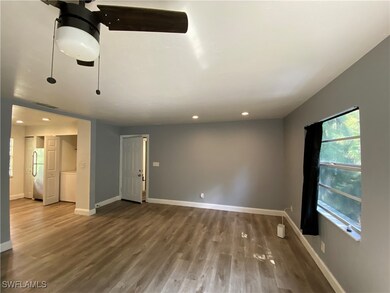 Empty room featuring wood finished floors, baseboa