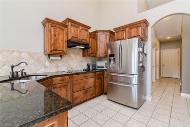 Large kitchen with stainless appliances and granite counters.