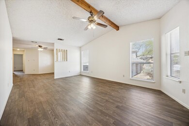 Unfurnished living room featuring a textured ceil
