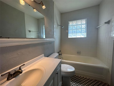 Bathroom featuring a textured wall, shower / bath 