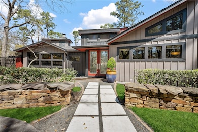 Front walk way with concrete pavers and black rock