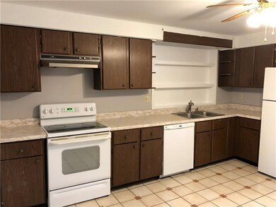 Kitchen features matching white appliances and jus