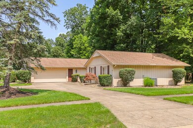 Ranch-style house featuring a front yard, garage, 