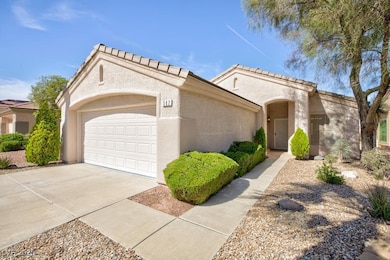 View of front facade with concrete driveway, a gar