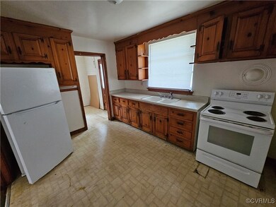 Kitchen featuring white appliances and sink