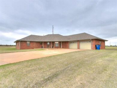 Ranch-style house featuring a front yard and a gar