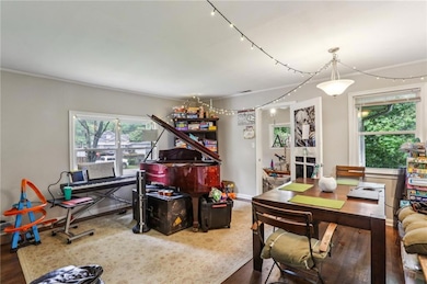 Dining space with wood finished floors and baseboards