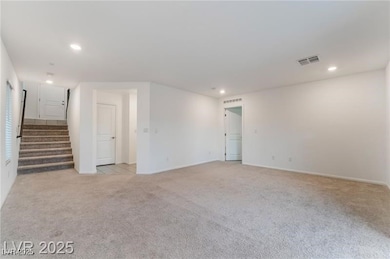 Unfurnished room with light colored carpet, recess
