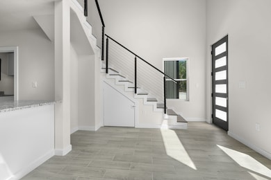 Entrance foyer featuring a high ceiling and stairway