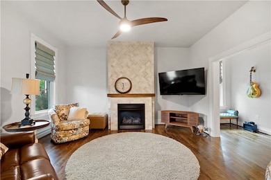 Living room features travertine ribbon gas firepla