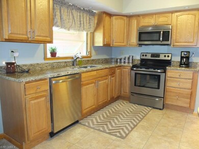 Kitchen has stainless steel appliances, granite co