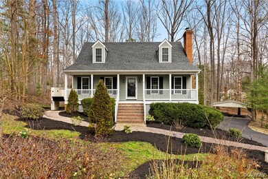 Cape cod house featuring a porch