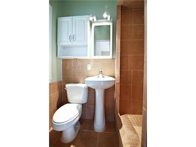 Bathroom with tile walls, toilet, and tile patter