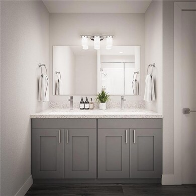 Bathroom with double vanity, baseboards, and a sin