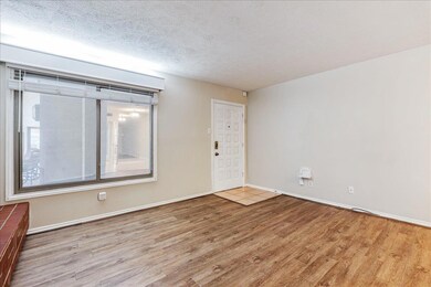 Spare room with wood finished floors, baseboards,